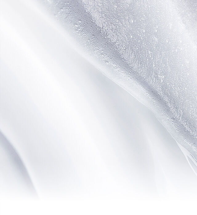 Primo piano sulla texture trasformativa della crema detergente che si trasforma in schiuma.